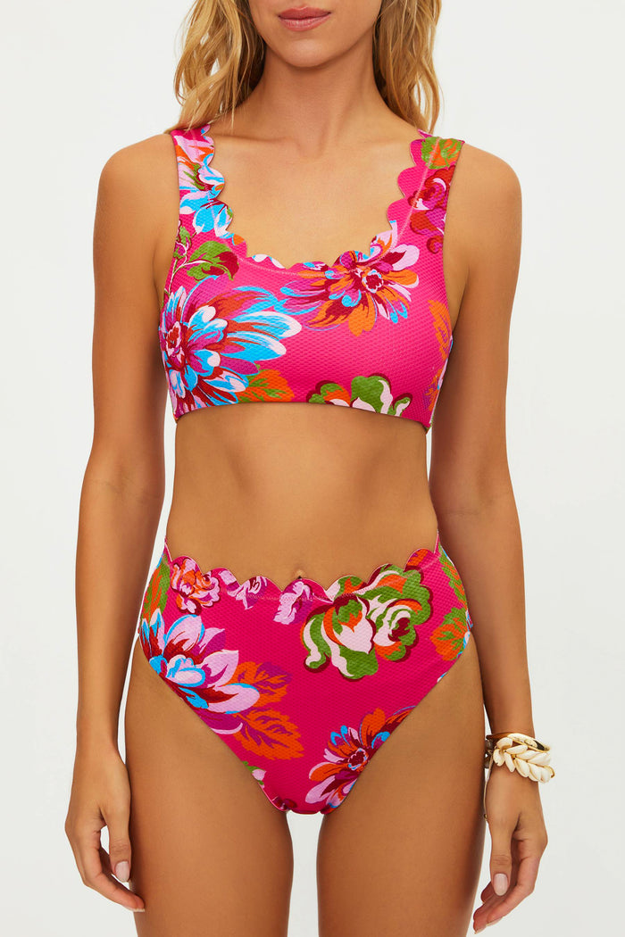 Woman wearing a colorful floral bikini set on a white background