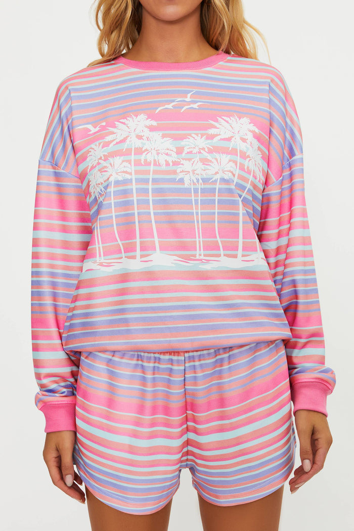 Woman wearing a colorful striped pajama set on a white background