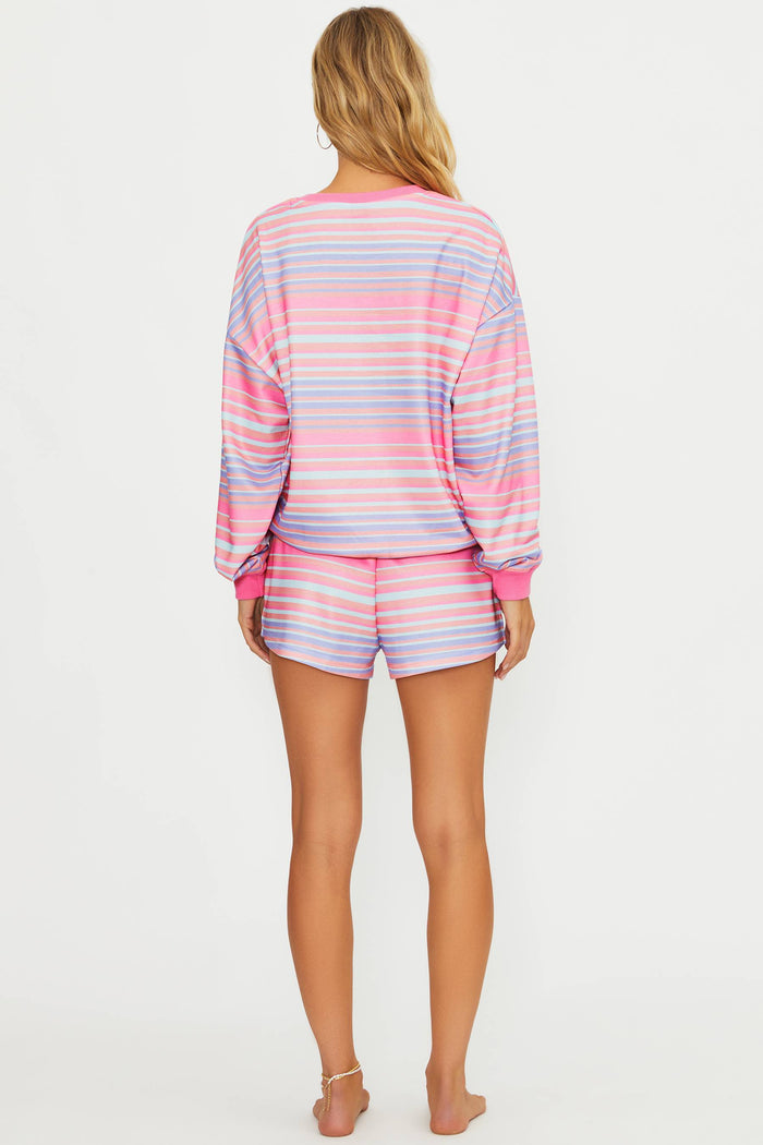 Woman wearing a striped pajama set on a white background