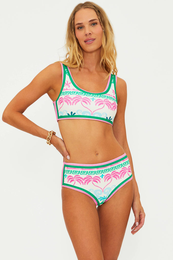A person wearing a tropical palm floral print swim bottom.