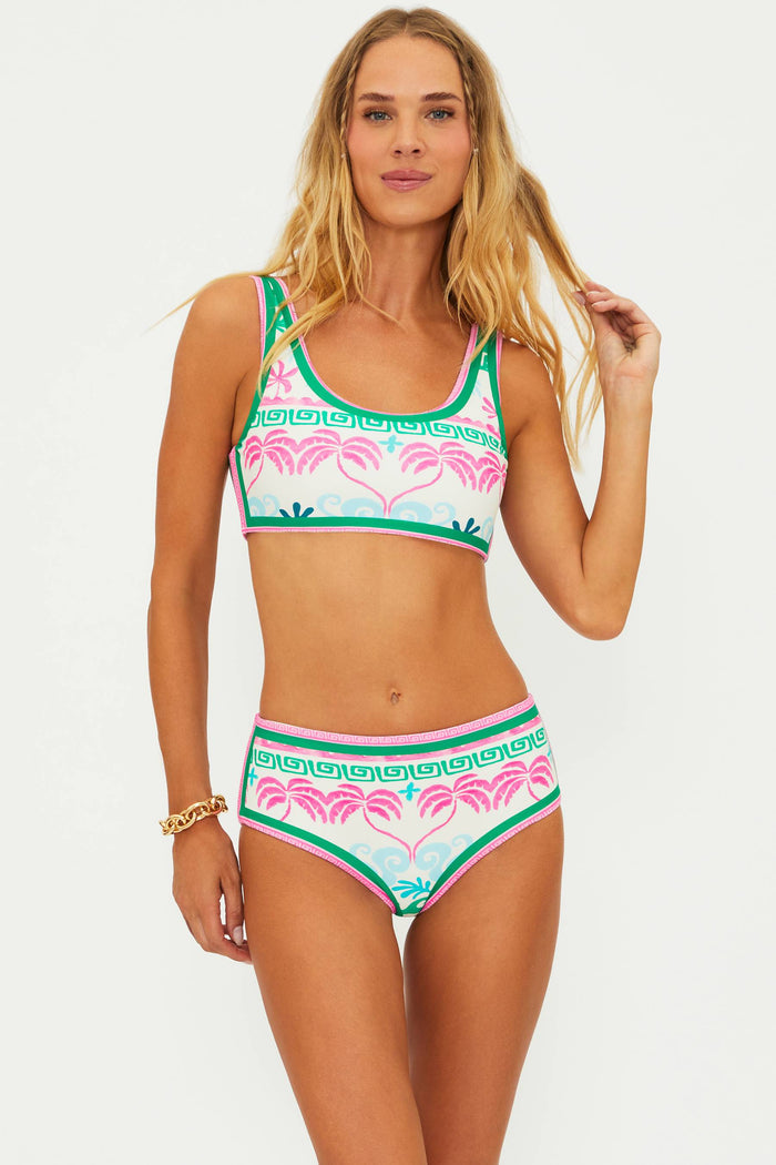 A person wearing a tropical palm floral print swim bottom.