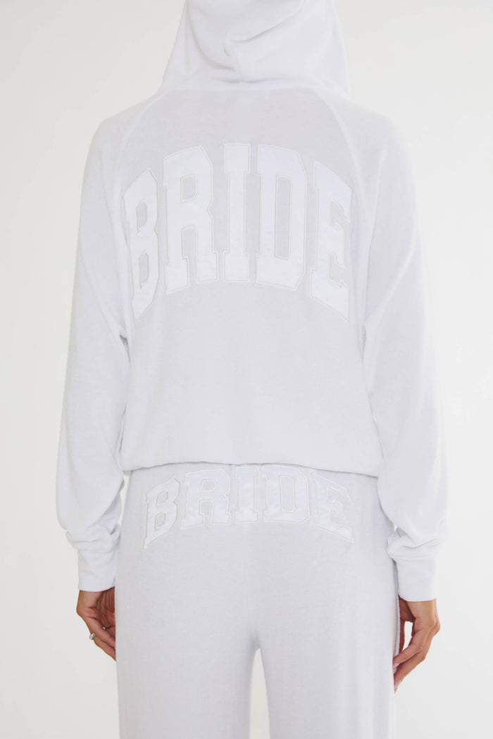 White zip up sweatshirt with "bride" text on the back