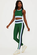 Person wearing a green and white athletic outfit on a white background