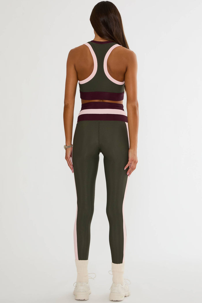 Olive green ribbed legging with maroon and pink lining.