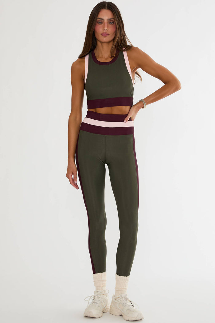 Olive green ribbed legging with maroon and pink lining.