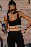 Woman in athletic wear holding a water bottle on outdoor steps
