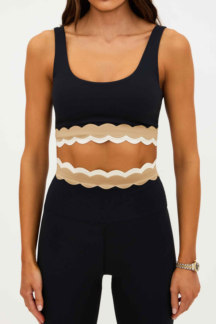 Black tank top with a beige scalloped hem on a white background