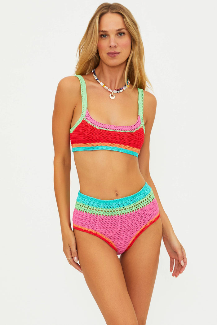 Woman wearing a colorful crochet bikini set on a white background