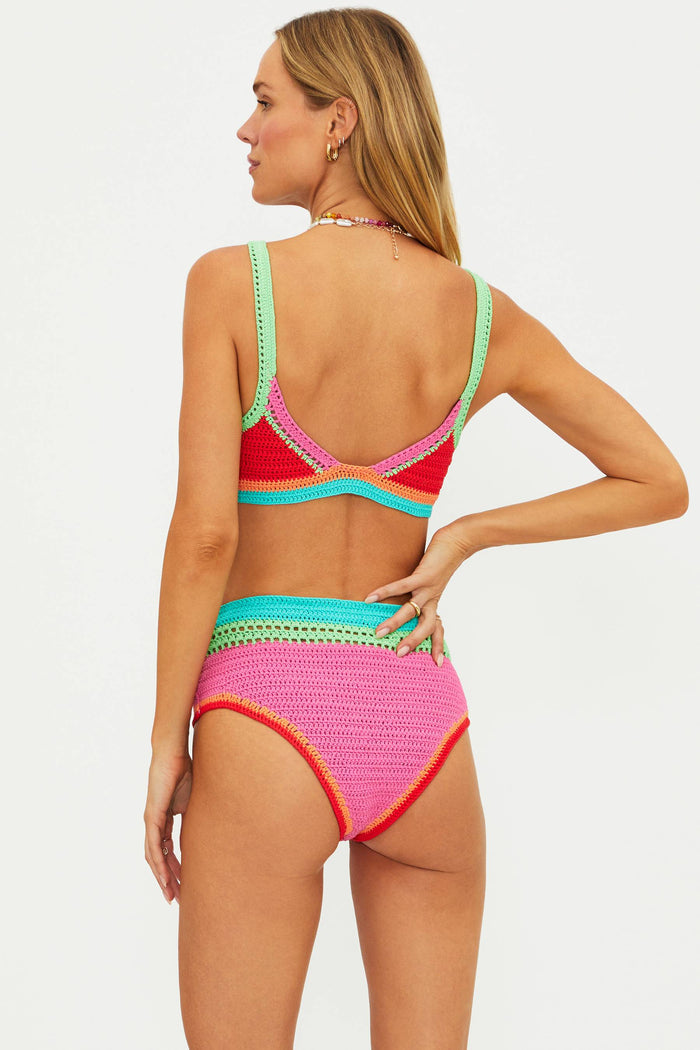 Woman wearing a colorful bikini with a white background