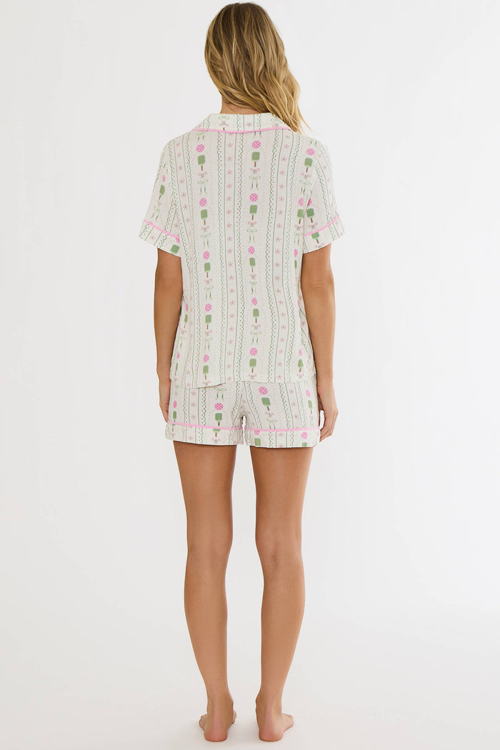Woman wearing a patterned pajama set on a white background