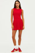 Woman wearing a red dress with white socks and red sneakers on a white background