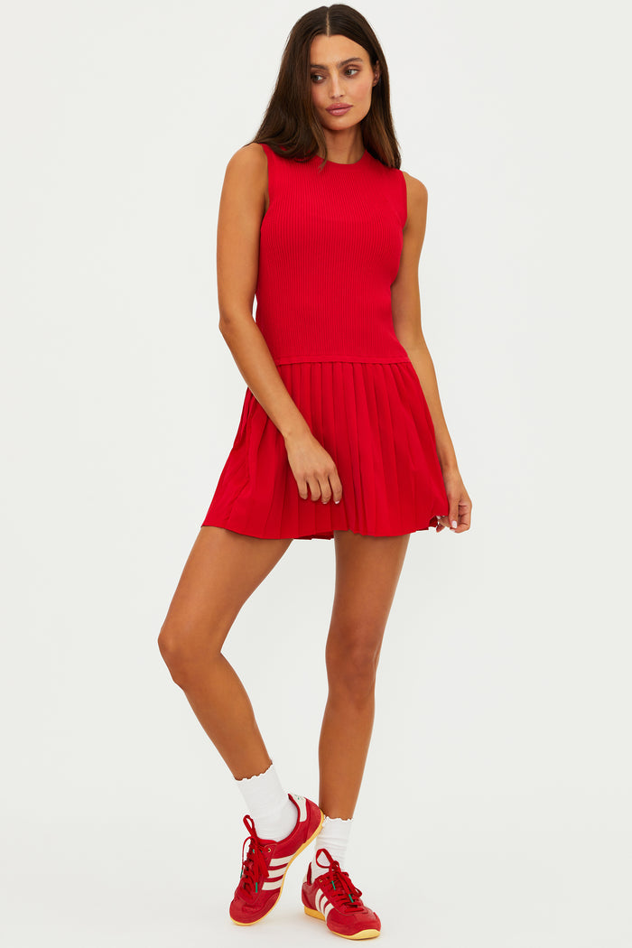 Woman wearing a red dress with white socks and red sneakers on a white background