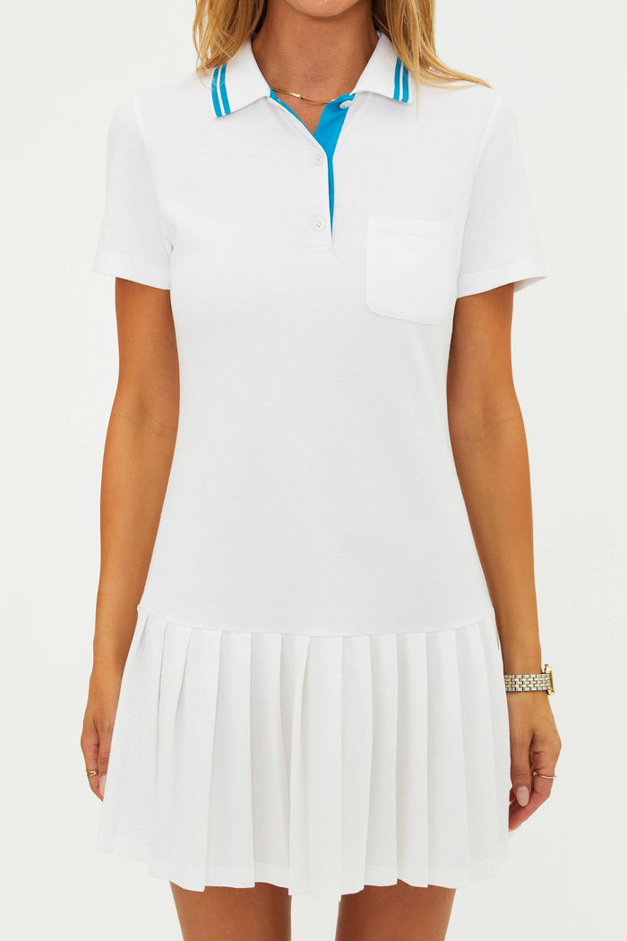 White dress with blue trim worn by a model on a white background