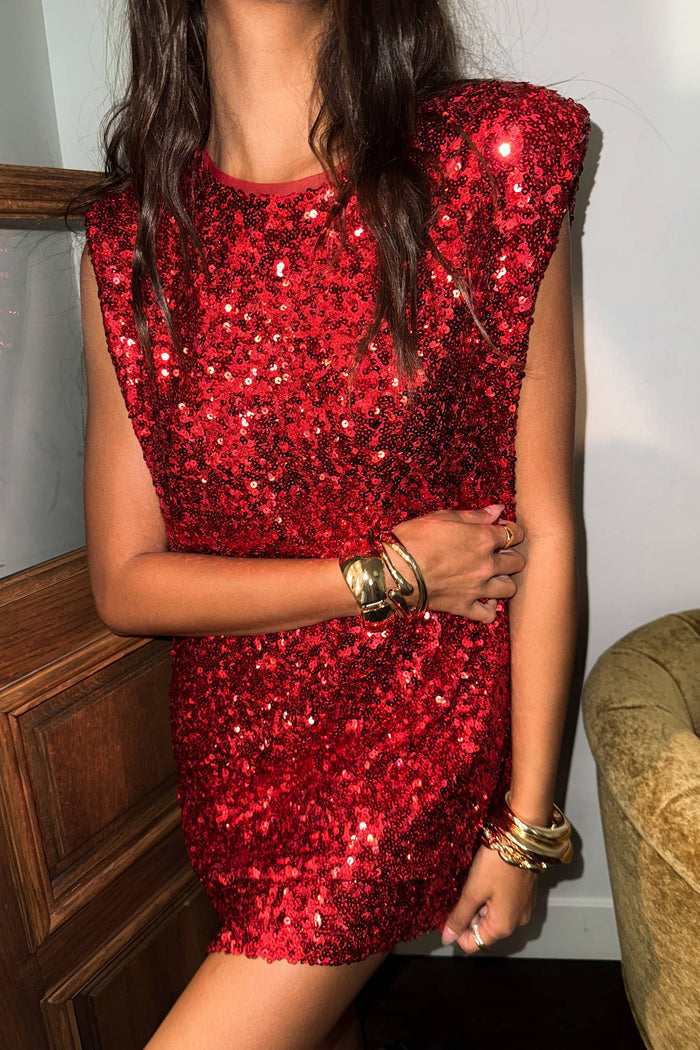Red sequin dress worn by a person, with a neutral background