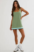 Woman wearing a green dress with a white background