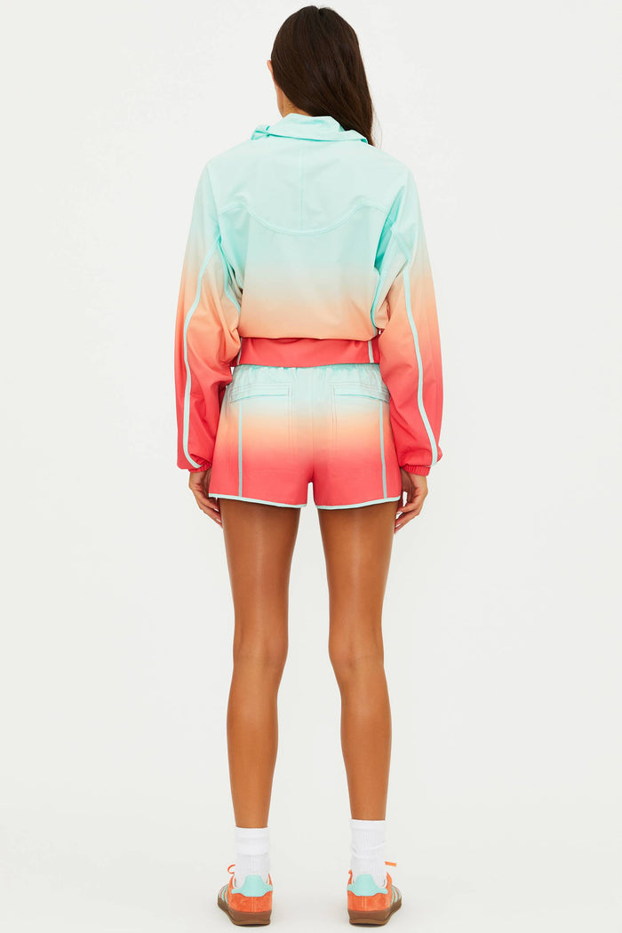 Person wearing a colorful ombre outfit on a white background