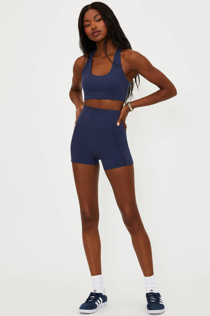 Woman wearing a blue athletic outfit on a white background