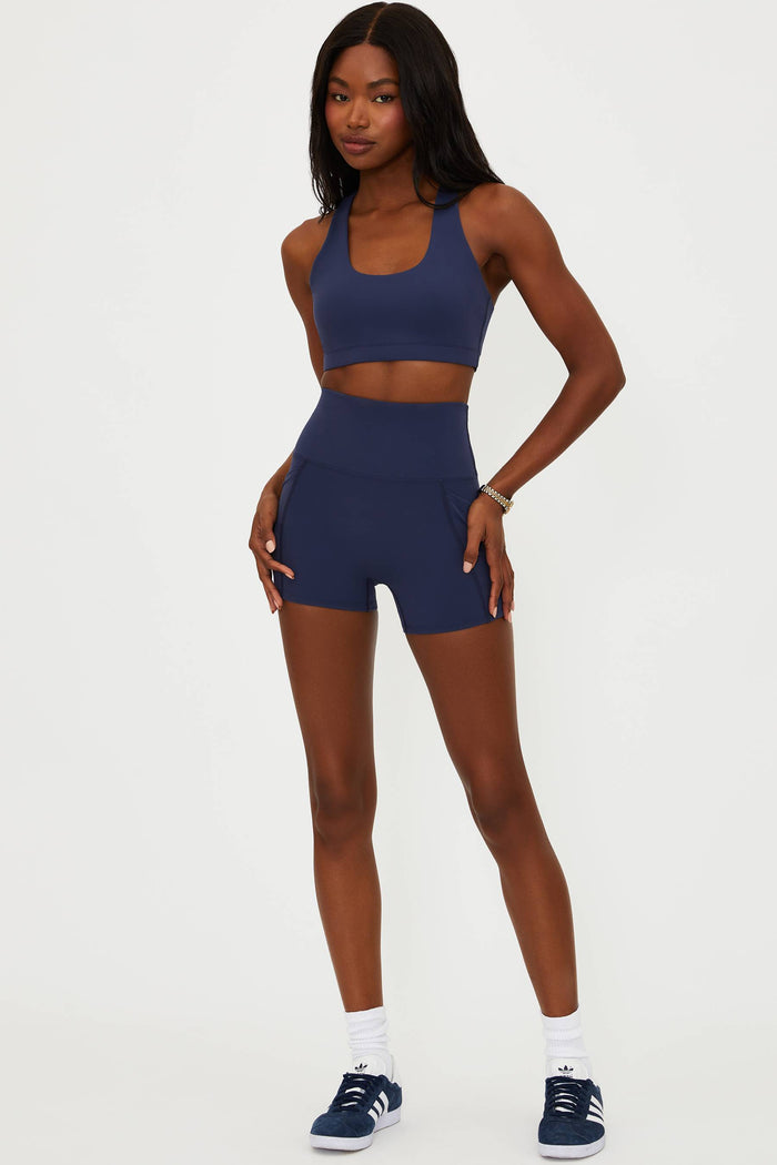 Woman wearing a blue athletic outfit on a white background