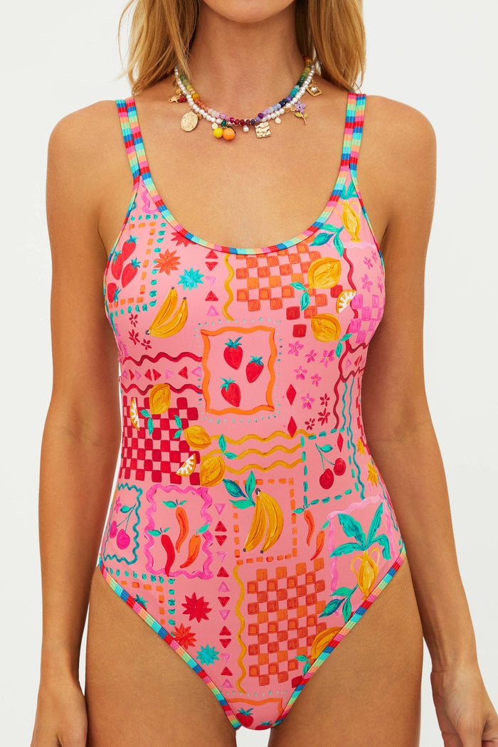 Colorful patterned swimsuit worn by a model on a white background