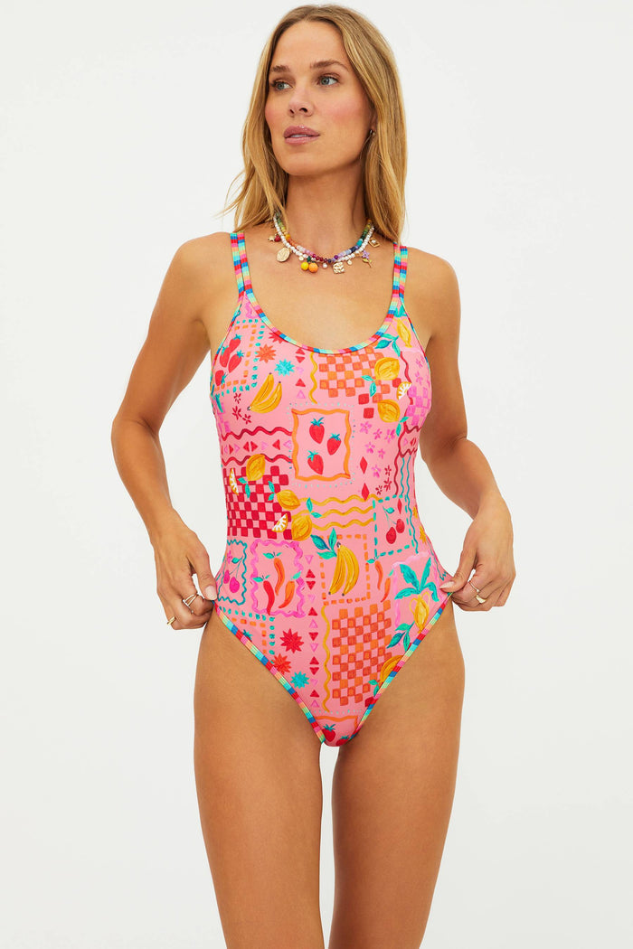 Woman wearing a colorful patterned swimsuit on a white background