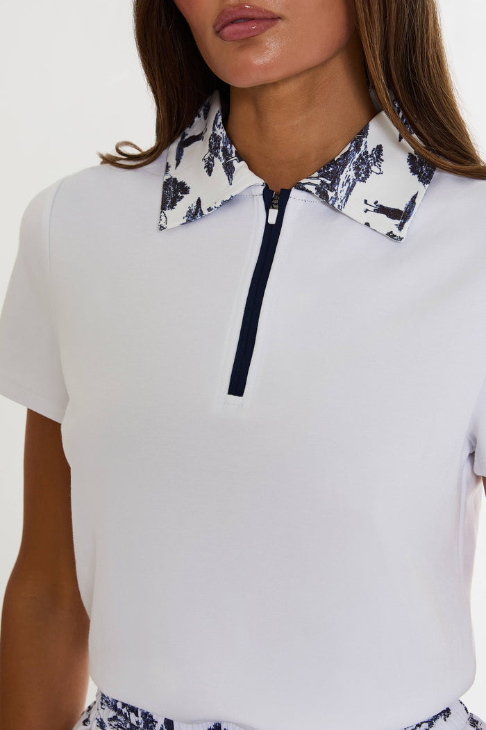 White polo shirt with floral collar and black zipper on a plain background