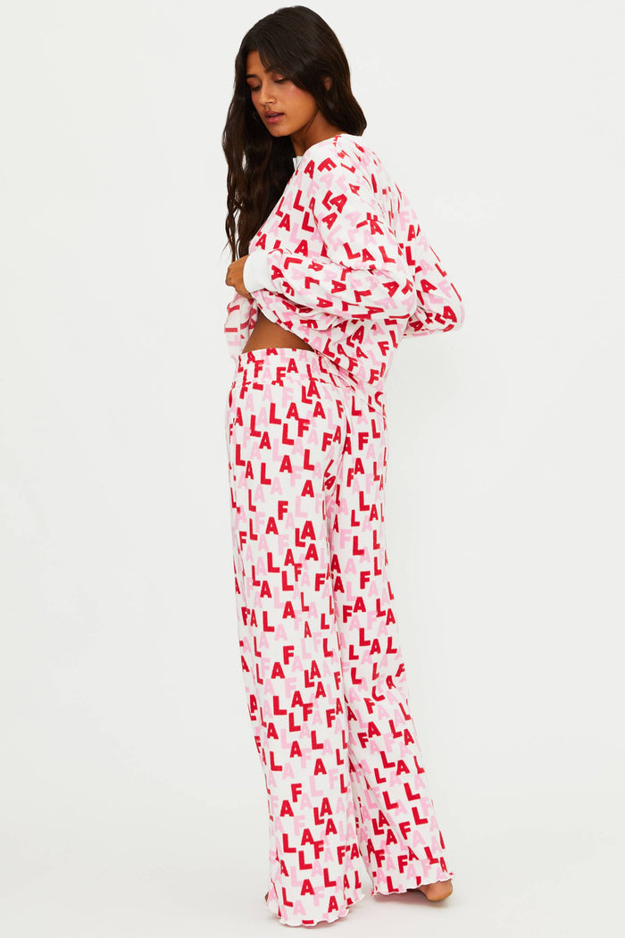 Woman wearing a white outfit with red text pattern on a white background