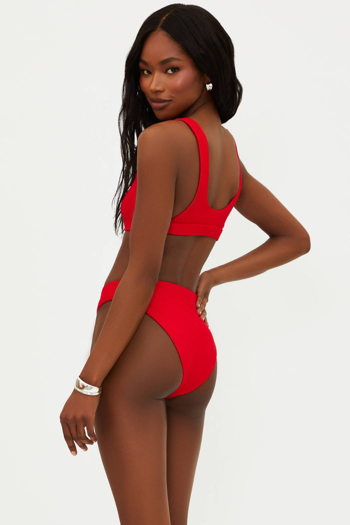A red bikini top with a scoop neck and fixed straps, made from ribbed fabric.