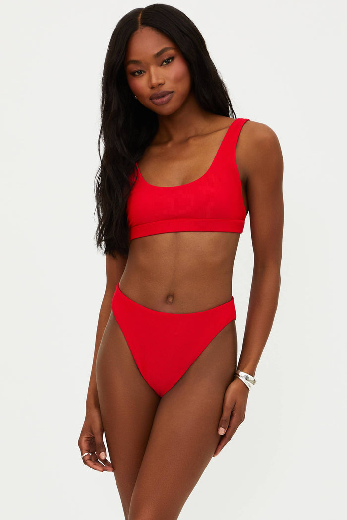 A red bikini top with a scoop neck and fixed straps, made from ribbed fabric.