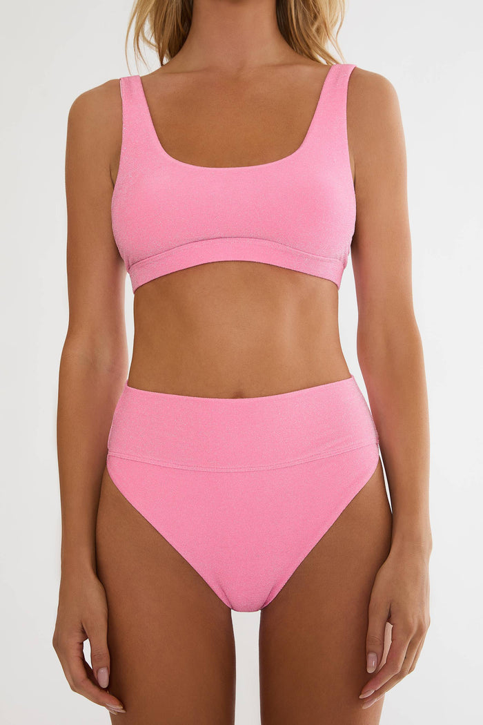 Person wearing a pink bikini set on a white background