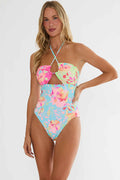 Woman wearing a colorful floral swimsuit on a white background