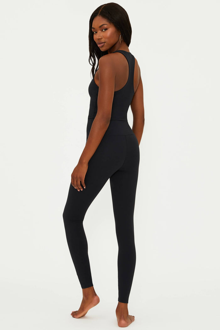 A model wearing black matte Piper legging and matching top, standing against a neutral background.