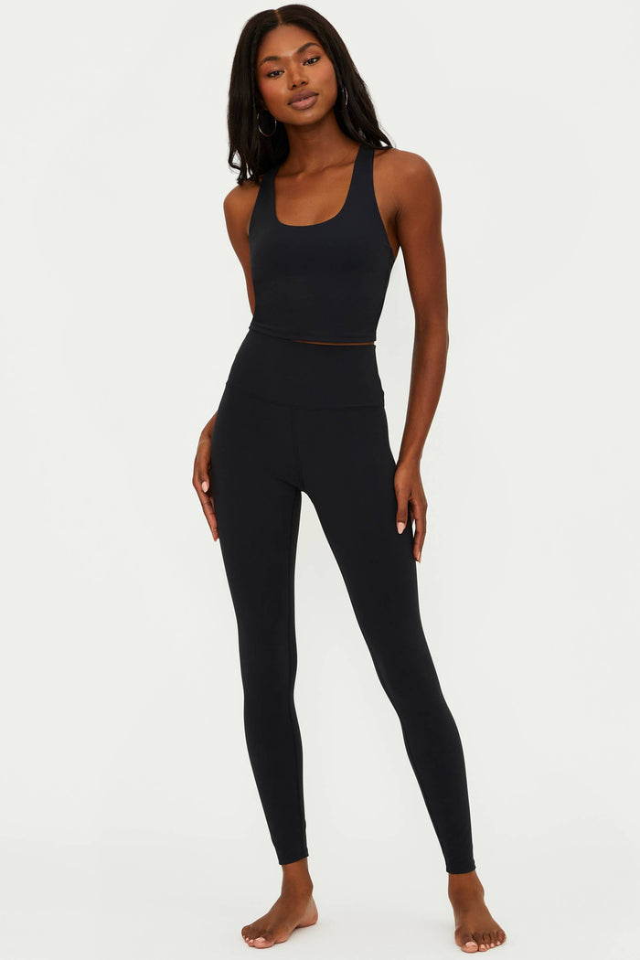 A model wearing black matte Piper legging and matching top, standing against a neutral background.