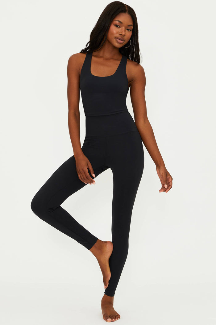 A model wearing black matte Piper legging and matching top, standing against a neutral background.