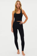 Model wearing high-rise black waffle textured full-length leggings with a waistband.