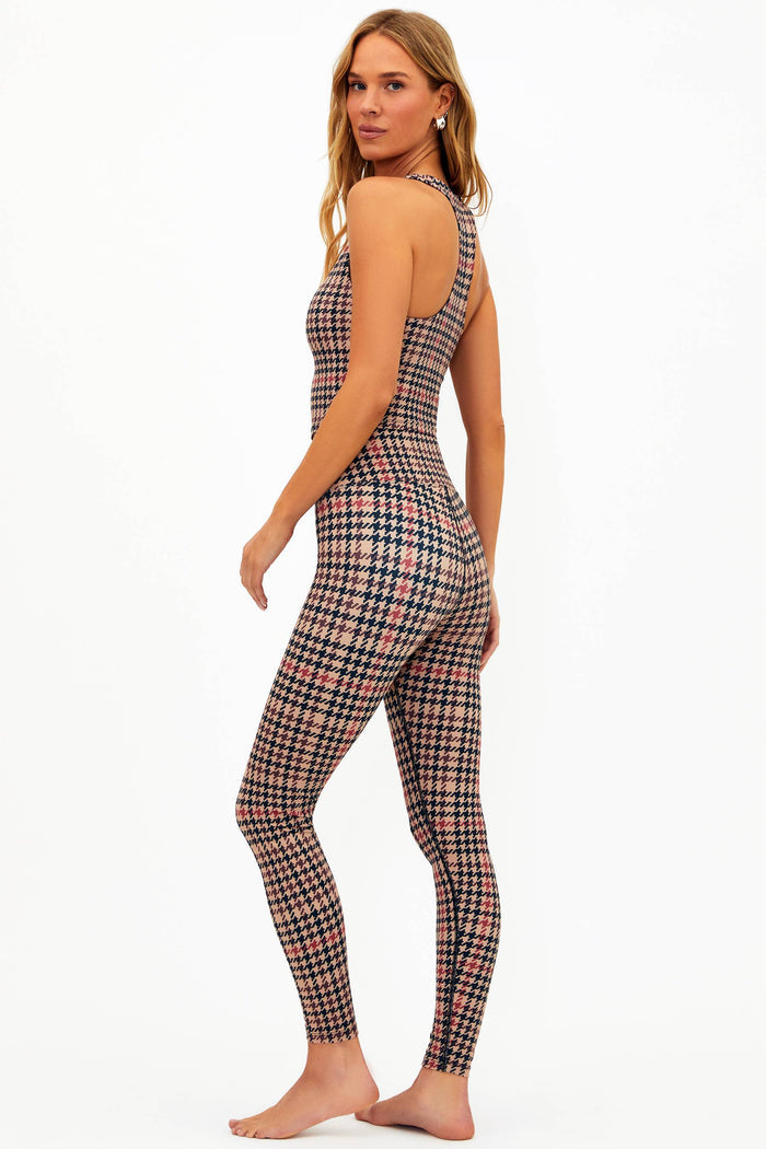Woman wearing a plaid sports bra and leggings set on a white background