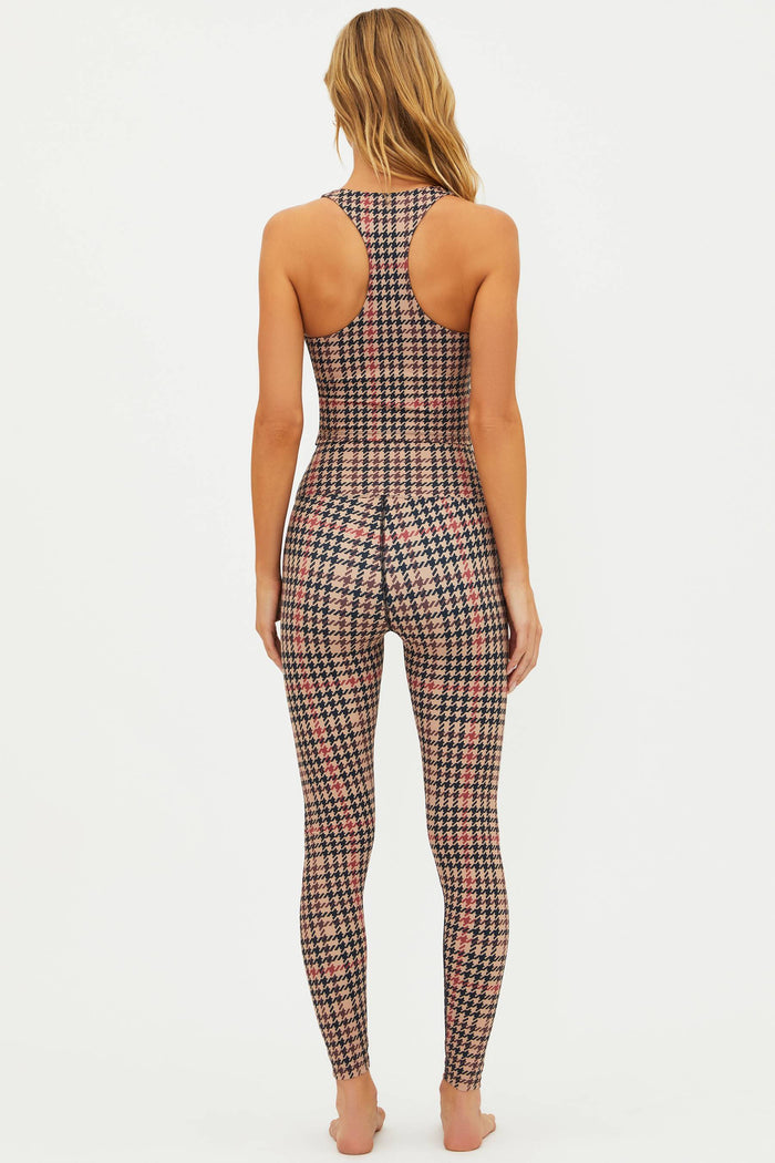 Woman wearing a plaid sports bra and leggings set on a white background