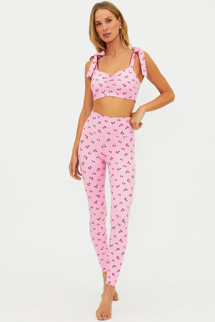 Woman wearing a pink floral outfit on a white background