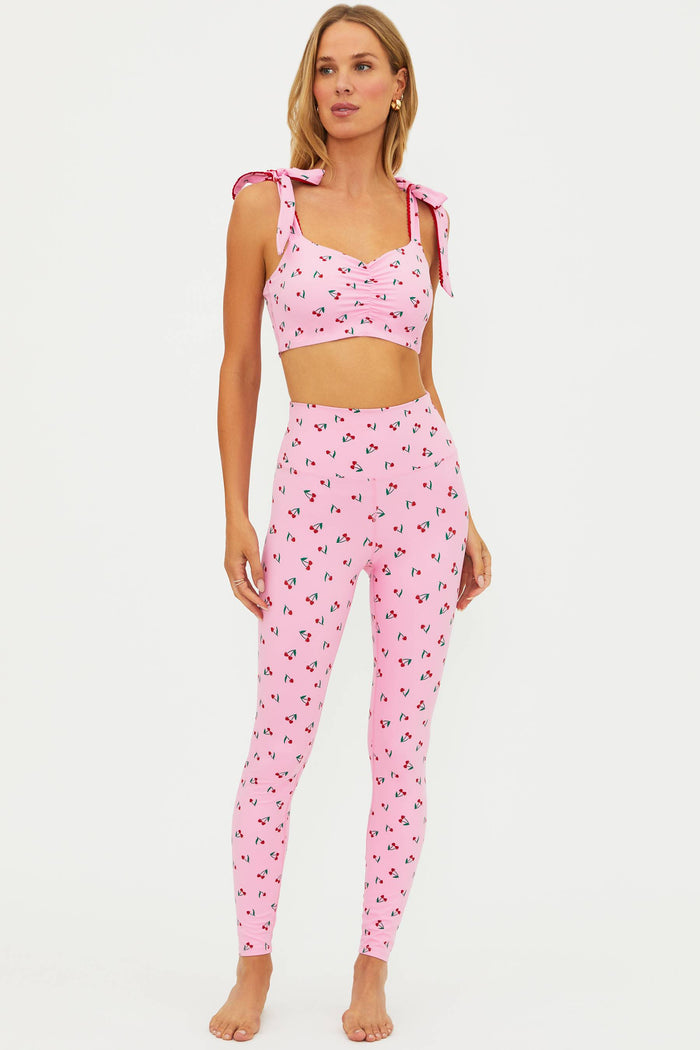Woman wearing a pink pajama set with a white background
