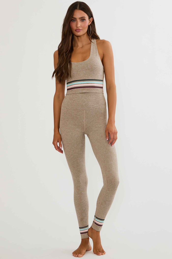 Beige high waisted legging with colorful lining around the ankles.