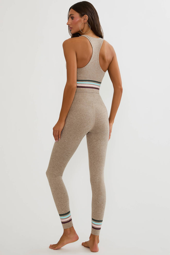 Beige high waisted legging with colorful lining around the ankles.