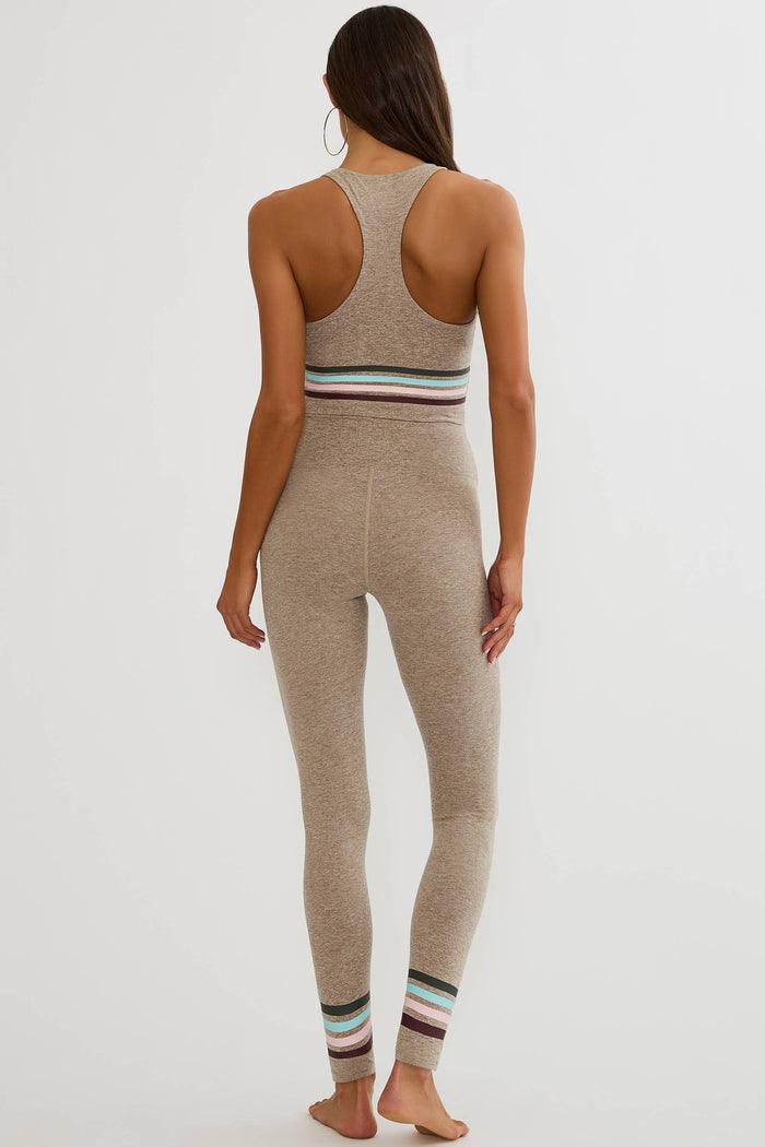 Beige high waisted legging with colorful lining around the ankles.