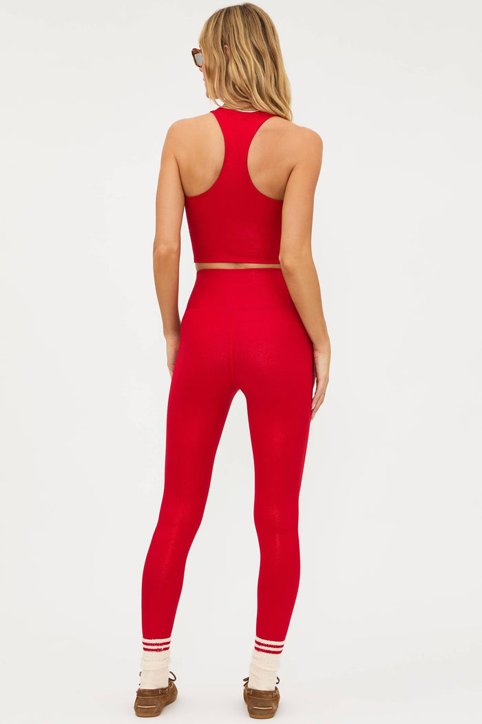 Person wearing a red athletic outfit on a white background