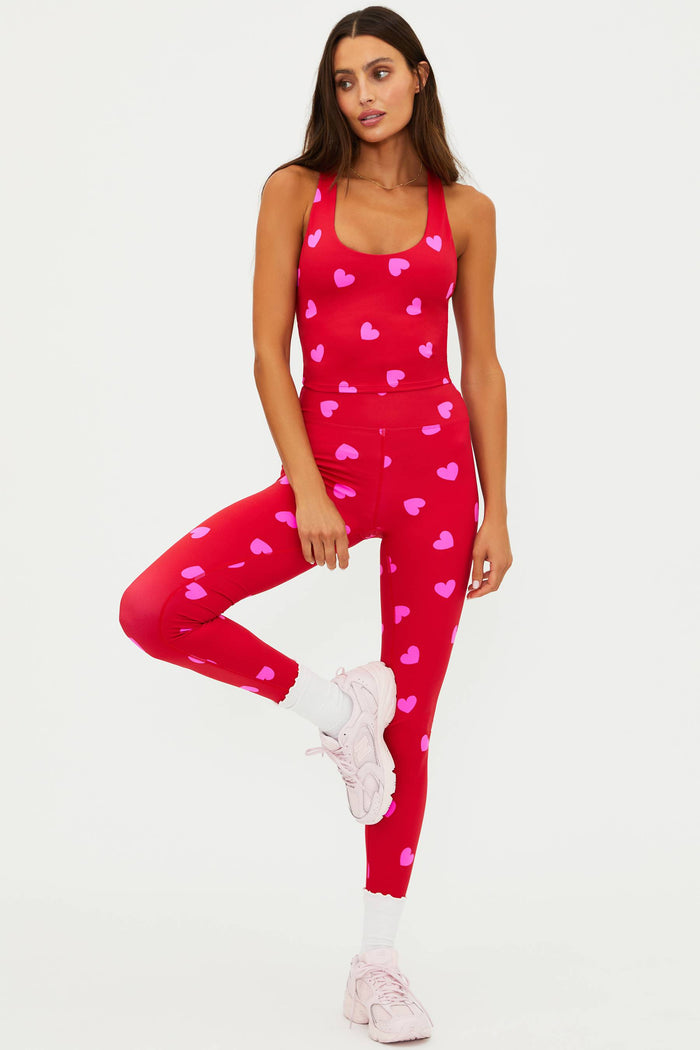 Woman wearing a red heart-patterned outfit on a white background