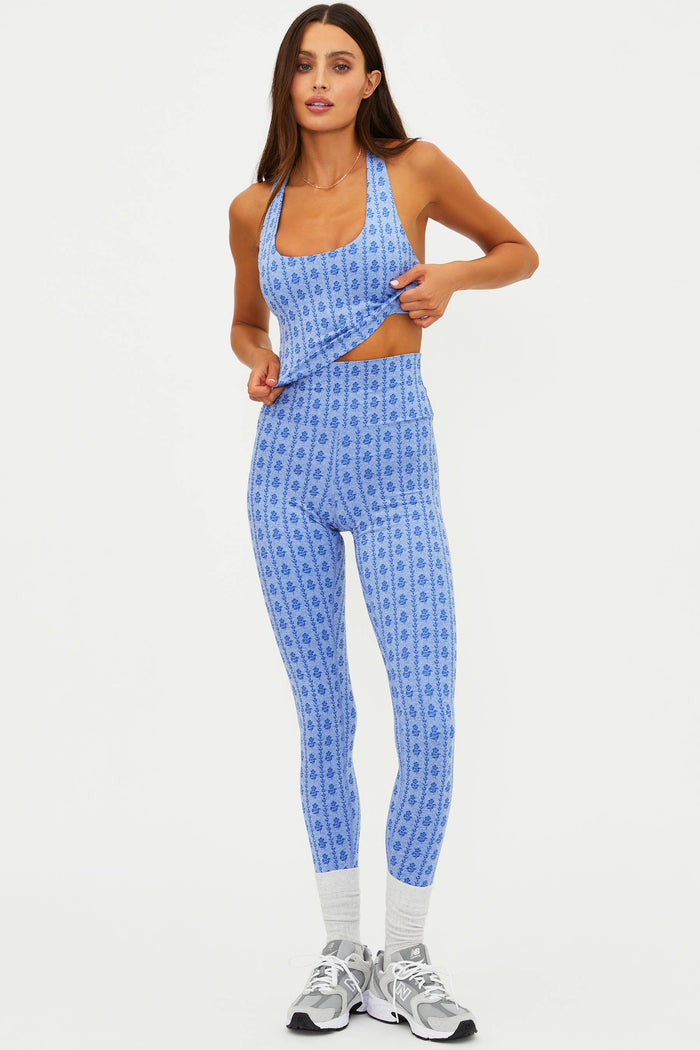 Woman wearing a blue patterned outfit on a white background