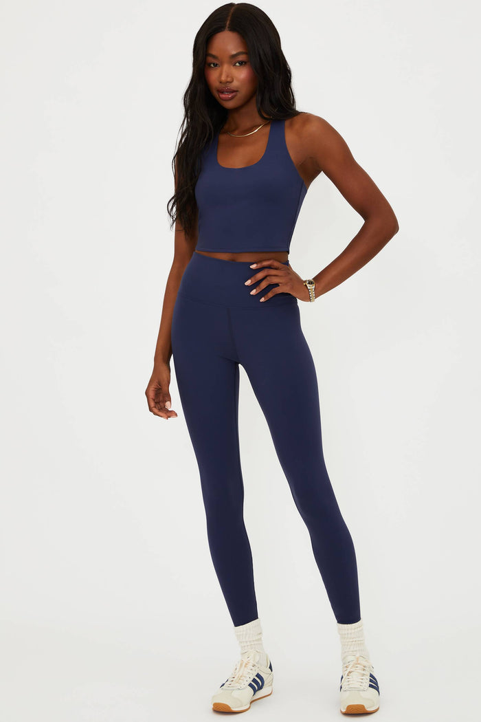 Woman wearing a blue athletic outfit on a white background