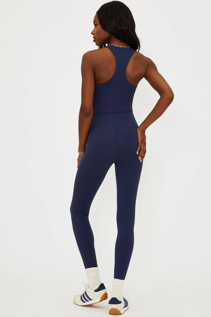 Woman wearing a blue athletic outfit on a white background