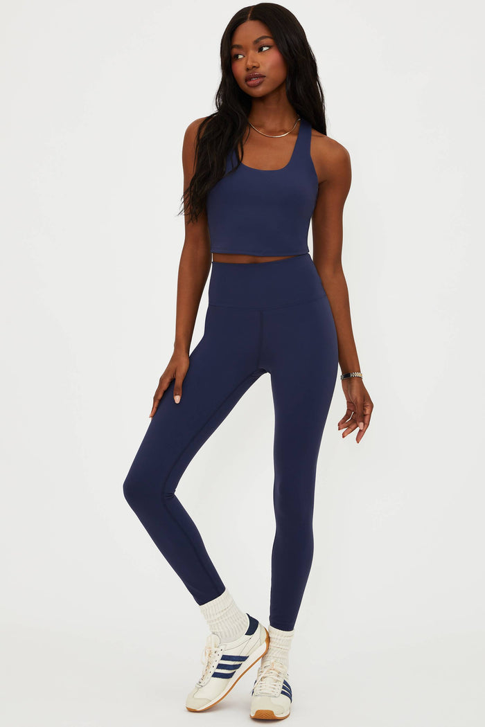 Woman wearing a blue athletic outfit on a white background
