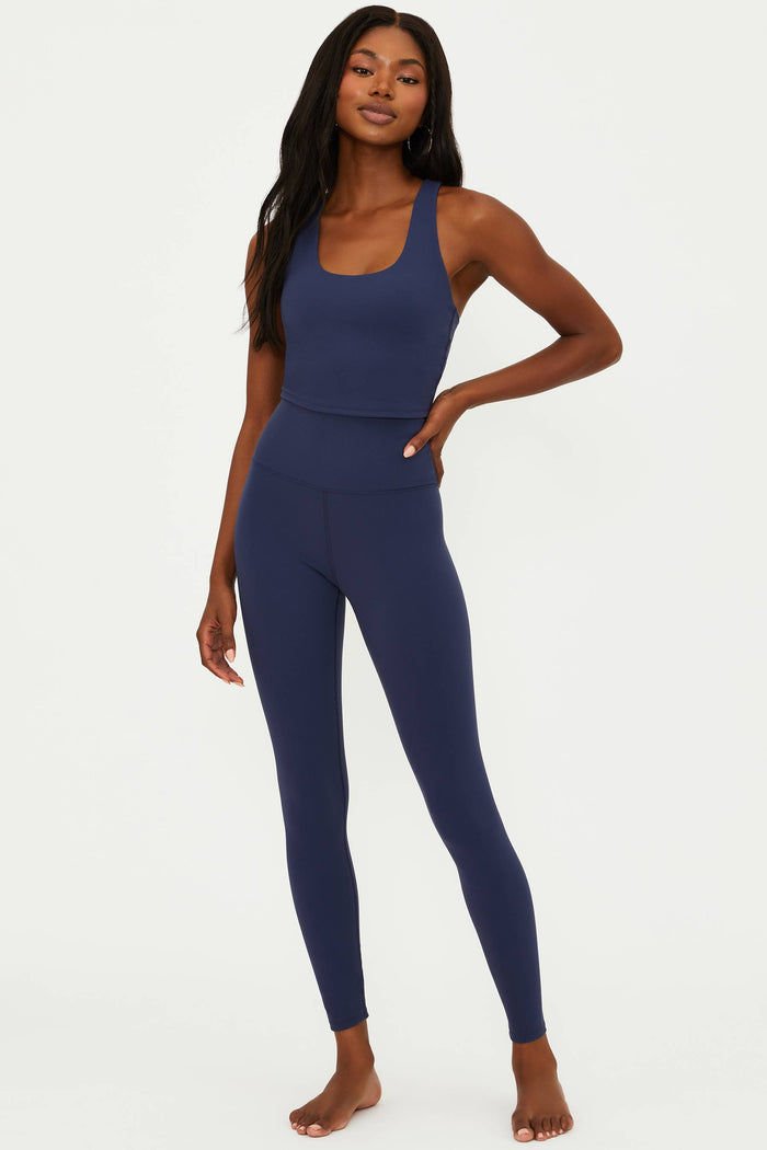 Woman wearing a blue athletic outfit on a white background