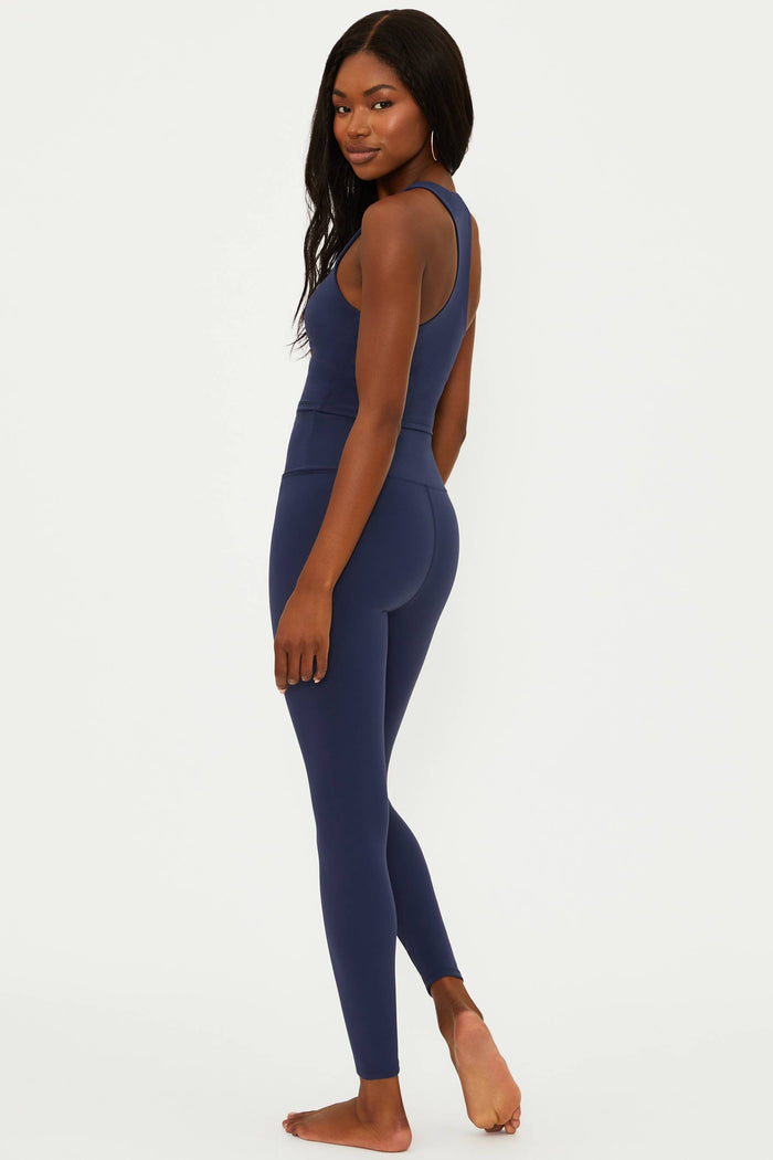 Woman wearing a blue athletic outfit on a white background