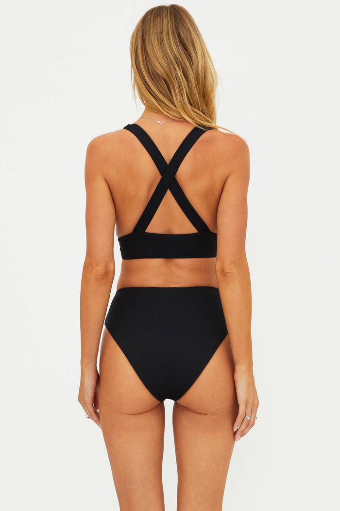 Black bikini set with criss-cross straps on a white background
